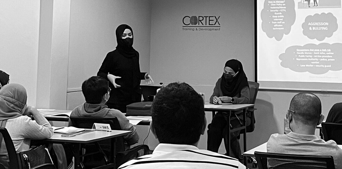 A tutor presenting to a class at Cortex Training and Development in Jerudong
