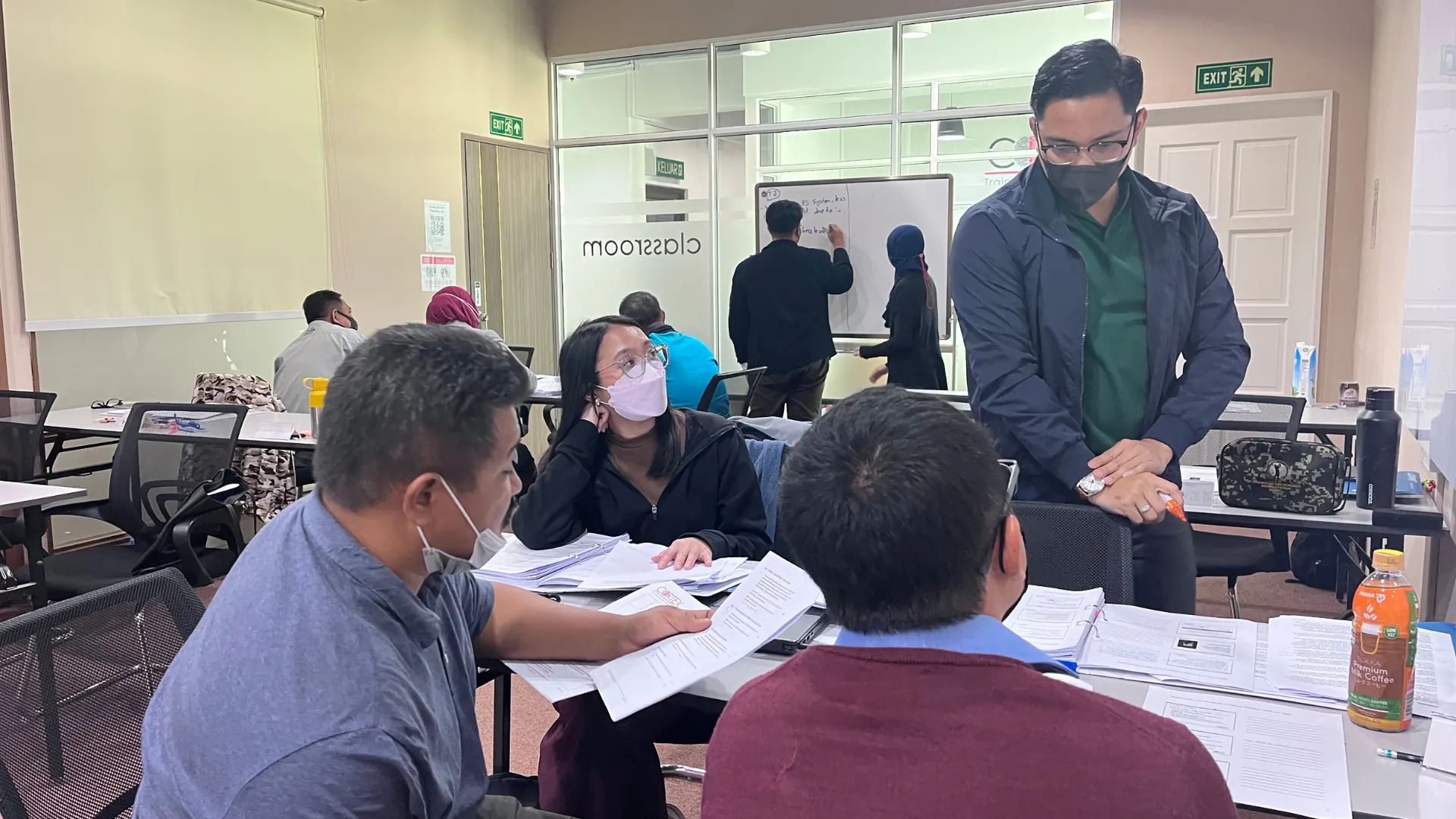 Learners working through course material in a training room